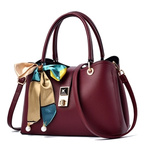 Elegant wine red lychee leather handbag with silk scarf and gold twist lock closure