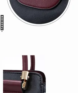 Close-up of gold-tone hardware and precise stitching on burgundy and black tote bag