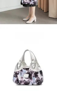 Macro detail of floral print nylon handbag with leather handles and silver hardware