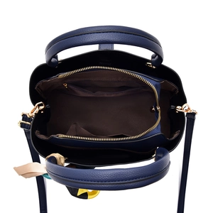 Dark blue top-handle bag with lychee texture and organized interior compartments