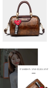 Brown faux crocodile leather pillow bag featuring a red heart charm and dual handles