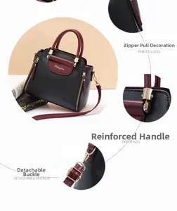 Detail view of reinforced handle, decorative zipper pull, and detachable metal buckle