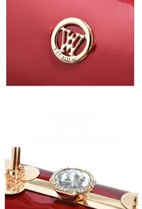 Macro shot of red patent leather evening bag with gold frame and large diamond clasp