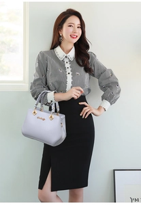 Detail of lavender leather handbag with metal handles and office fashion outfit