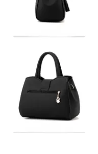 Detailed side and back view of black litchi pattern leather handbag with metal pendant