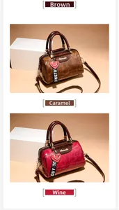 Detail view of vintage oil-wax texture boston bags in brown and wine red with gold zippers