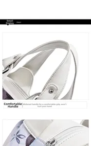 Detail of widened handle and floral print on white soft leather tote bag with stitching