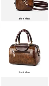 Detail view of brown crocodile texture handbag with side D-ring and back zipper pocket
