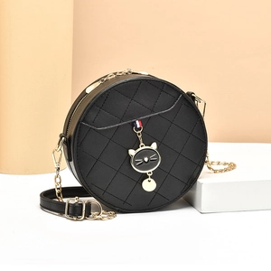 Chic black round crossbody bag with quilted stitching, cat charm, and chain strap
