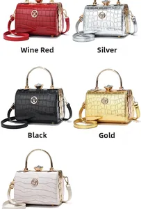 Detail of five croc-pattern evening bags with ring handles in red, silver, gold, and white