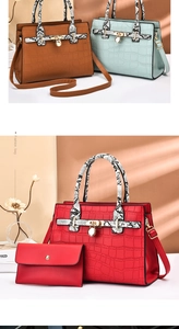 Detail of stone textured tote bag with snake print handles and golden metal buckle
