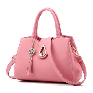 Pink lychee grain leather tote bag with tassel charm and adjustable crossbody strap