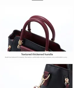Detail of reinforced wine red handles and premium PU leather texture on black handbag