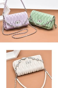 Detail of quilted leather mini bags in lilac, green and white with crystal chains