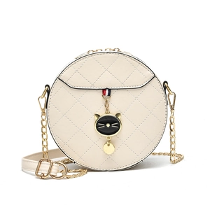 Quilted round crossbody bag in cream leather with cat charm and gold chain strap