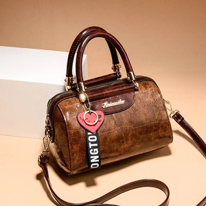 Brown crocodile pattern Boston bag with heart pendant and adjustable shoulder strap