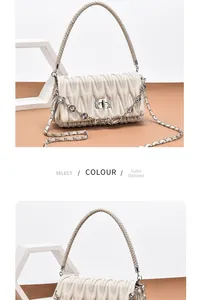 Detail of off-white pleated handbag featuring crystal metal chain and woven top handle