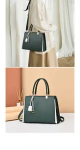 Detail of dark green tote bag featuring matte texture with side stripes and tassel charm