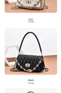 Detail of quilted matelassé handbag with crystal-encrusted chain and woven handle
