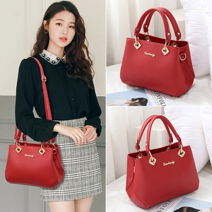 Elegant red leather wedding handbag for brides with top handle and gold shoulder strap