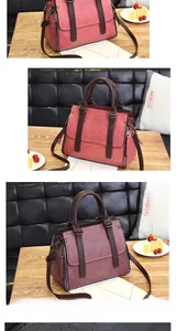 Detail view of red lychee textured leather bag with dark brown handles and side zippers