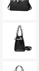 Detail view of black crocodile pattern handbag featuring snake print handle and gold hardware