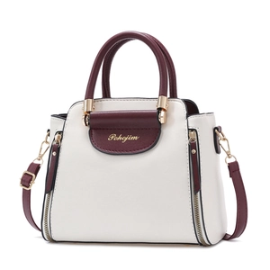 Minimalist beige and burgundy crossbody handbag with gold hardware and top handle