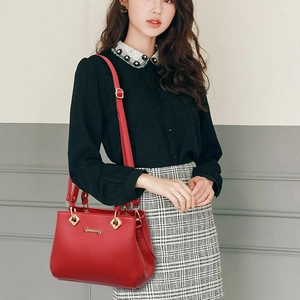 Elegant red leather handbag with gold logo and shoulder strap for wedding occasions