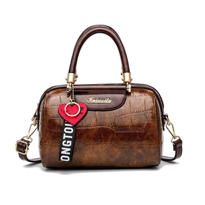Brown crocodile embossed leather pillow bag with dual handles and logo for women