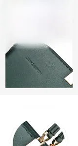 Detail of dark green leather handbag with lychee texture and golden metal hardware