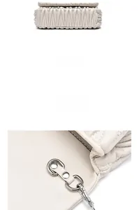Detail view of cream Matelassé handbag showing the bottom structure and silver metal lock