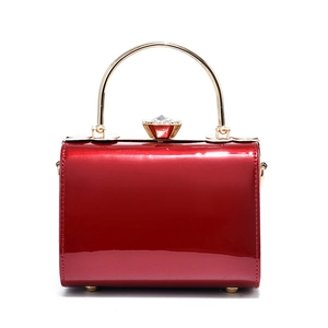 Elegant red patent leather evening handbag with gold metal handle and crystal buckle