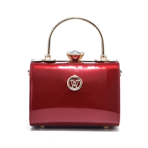 Glossy red metallic leather handbag with gold handle and crystal clasp for women