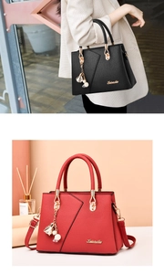 Close-up of litchi texture leather handbags in black and red with gold hardware detail