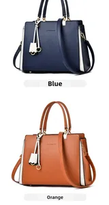 Detail view of large tote handbags in deep blue and orange with metallic buckles