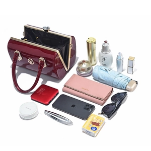 Glossy burgundy patent leather handbag showing spacious interior for daily essentials
