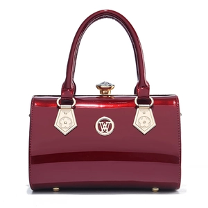 Glossy burgundy patent leather handbag with gold-tone hardware and round fashion logo