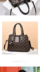 Detailed close-up of retro floral print handbag with golden buckle and bow detail