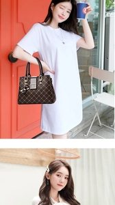 Outdoor shot of a classic tote bag featuring stylish floral print and gold bow charm detail