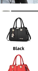 Detail of black and red litchi grain faux leather handbags with gold floral charms