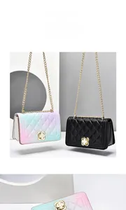 Detail of gradient blue and pink quilted leather bag with gold floral clasp and chain