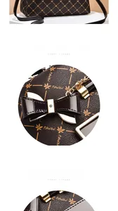 Detailed macro view of the printed leather bag with golden hardware and black bow charm