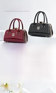Detail of red and black patent leather mini bags with gold beads and chain strap