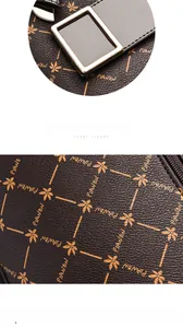 Detail shot of the vintage printed leather texture and gold square lock on the brown handbag