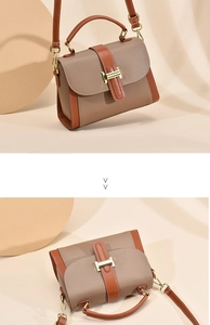 Detail of lychee pattern leather crossbody bag with golden H-buckle and red trim