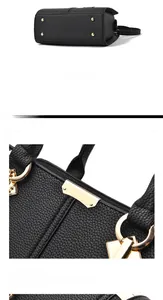 Detail of the black litchi texture bag showing golden protective bottom studs