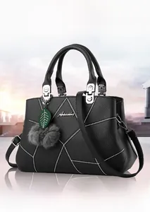 Black pebbled leather tote featuring white stitching, metal handles, and leaf charm detail