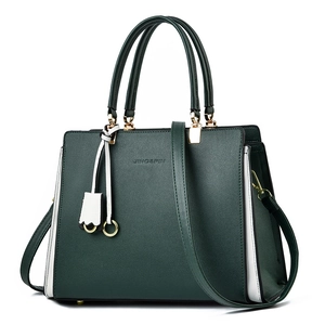 Dark green leather tote bag with white side stripes and gold hardware, 2025 fashion style