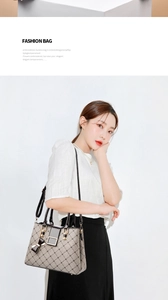 Detail of embroidered floral handbag with black leather handles and metallic square lock
