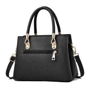 Elegant black lychee textured leather handbag with gold metal hardware and adjustable strap
